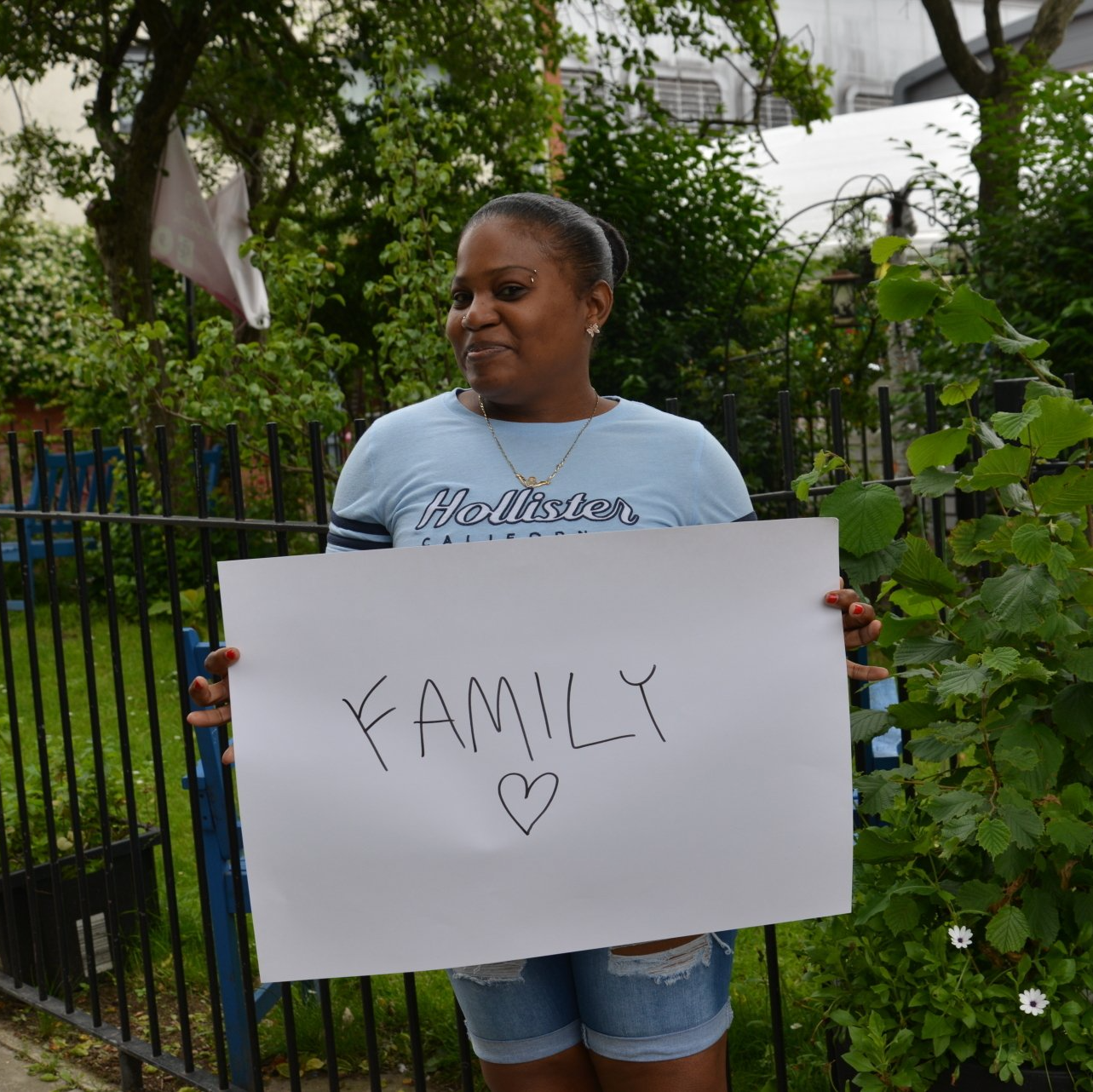 A woman is holding a sign that says family