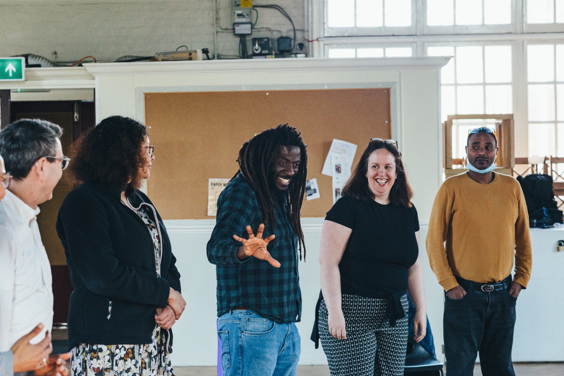 A group of people are standing next to each other in a room.