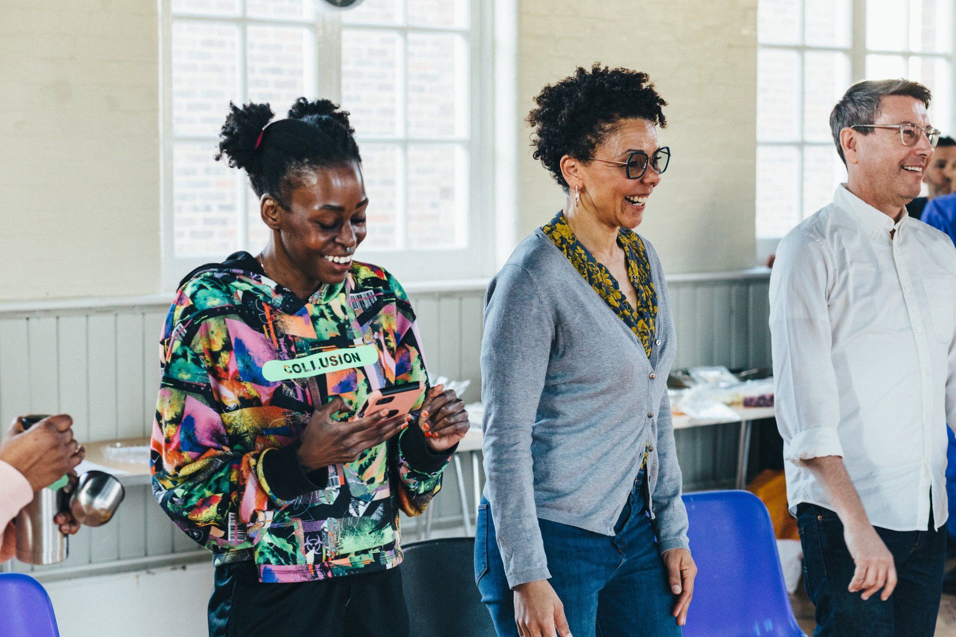 A group of people are standing next to each other in a room.