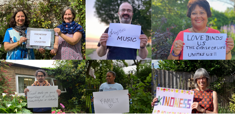 A group of people are holding signs in front of their faces.