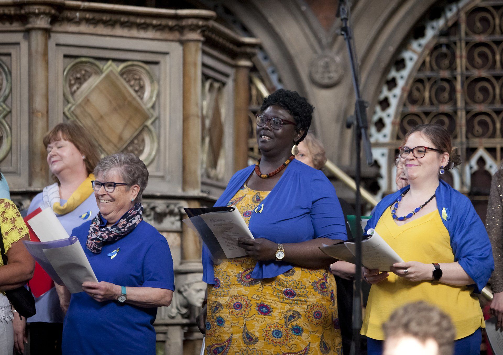A group of women are singing together in a church.