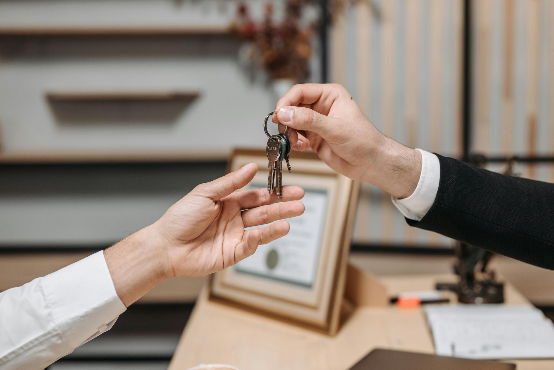 A lawyer is handing a key to landlord.