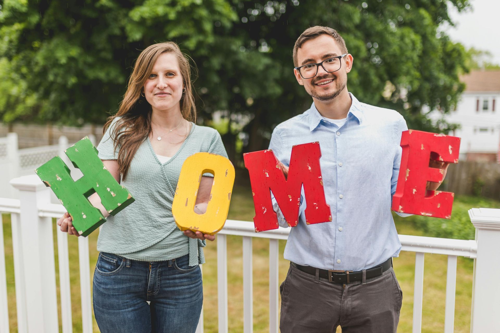 Couple holding letters spelling 