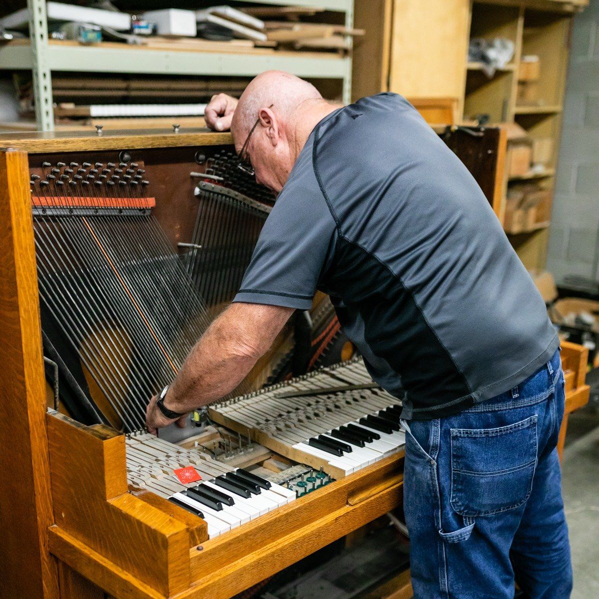 A Man Checking The Piano — Salt Lake City, UT — Barrus Pianos