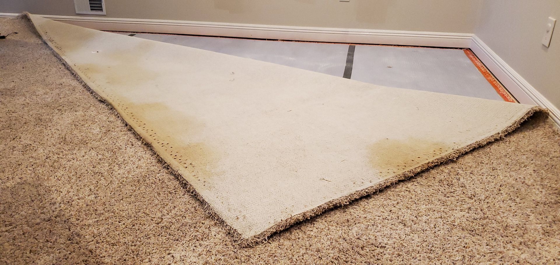 A piece of carpet is laying on the floor in a room.