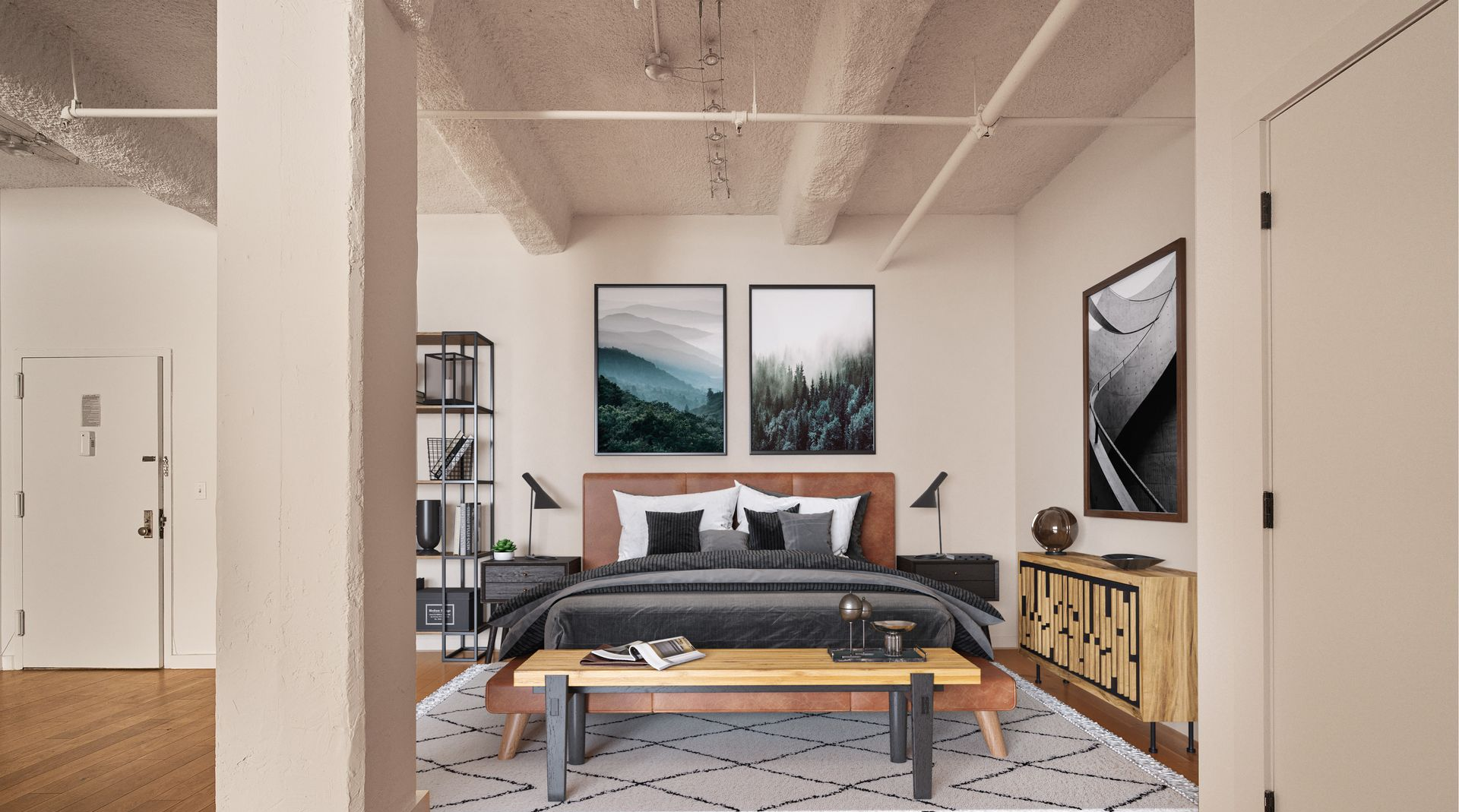 Bedroom interior with bed, art, bookshelves, and wooden furniture, neutral colors.