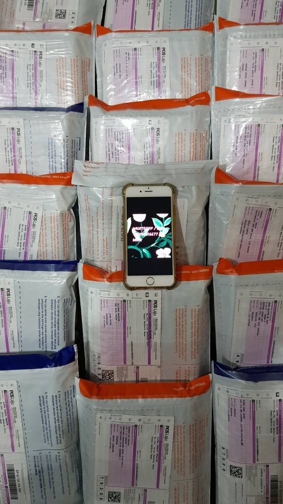 a bunch of poslaju parcel benig arrange with iphone on top of it