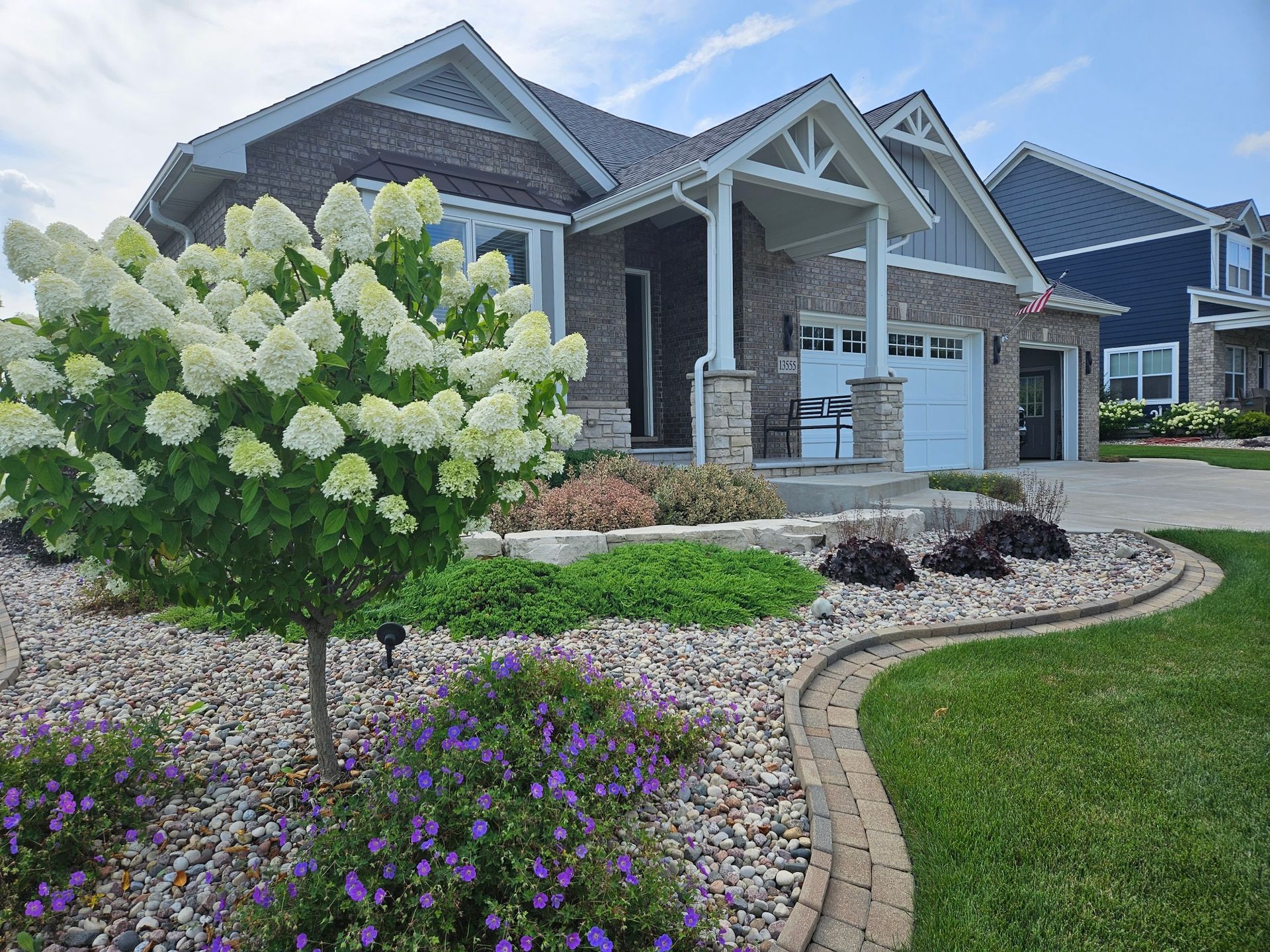 A house with a lot of flowers in front of it.