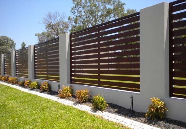 Brown horizontal slat fence with concrete pillars and small shrubs  — Precision Patios Toowoomba In Toowoomba, QLD