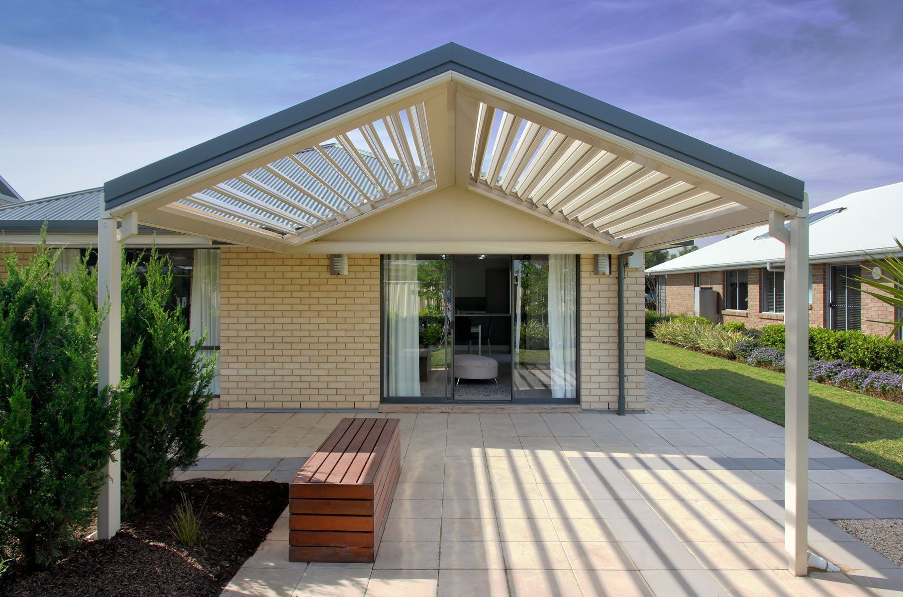 Patio with A Louvred Roof and Wooden Bench — Precision Patios Toowoomba In Toowoomba, QLD