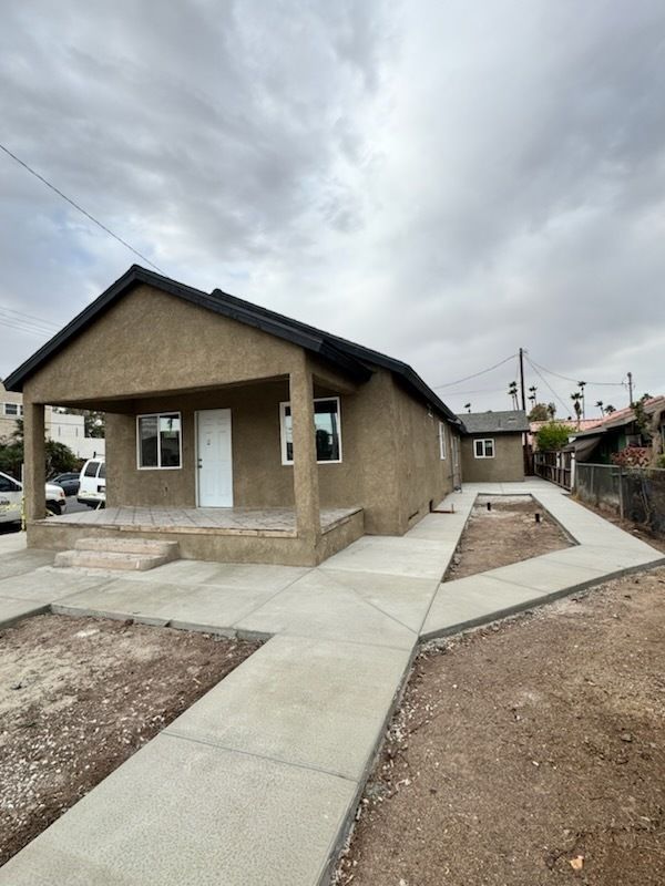 A house with a concrete walkway leading to it
