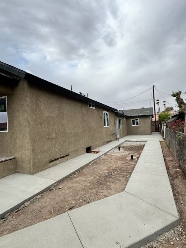 A house with a concrete walkway leading to it