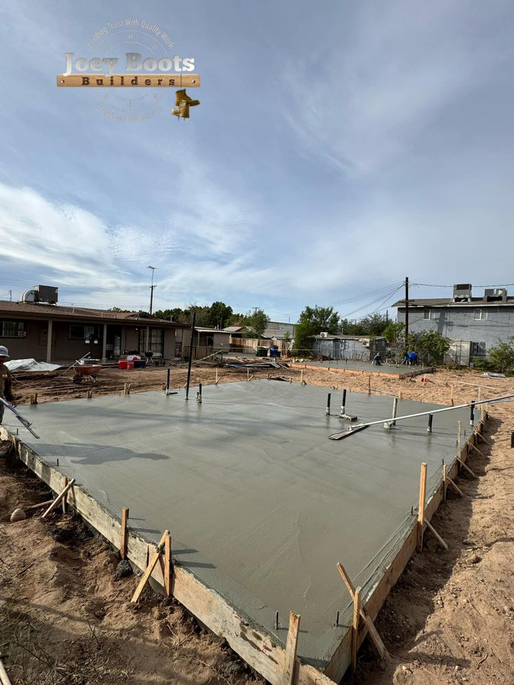 A concrete slab is being poured in a construction site.