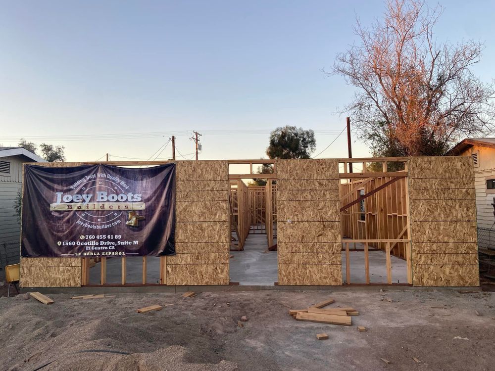 A building under construction with a sign that says jerry boots