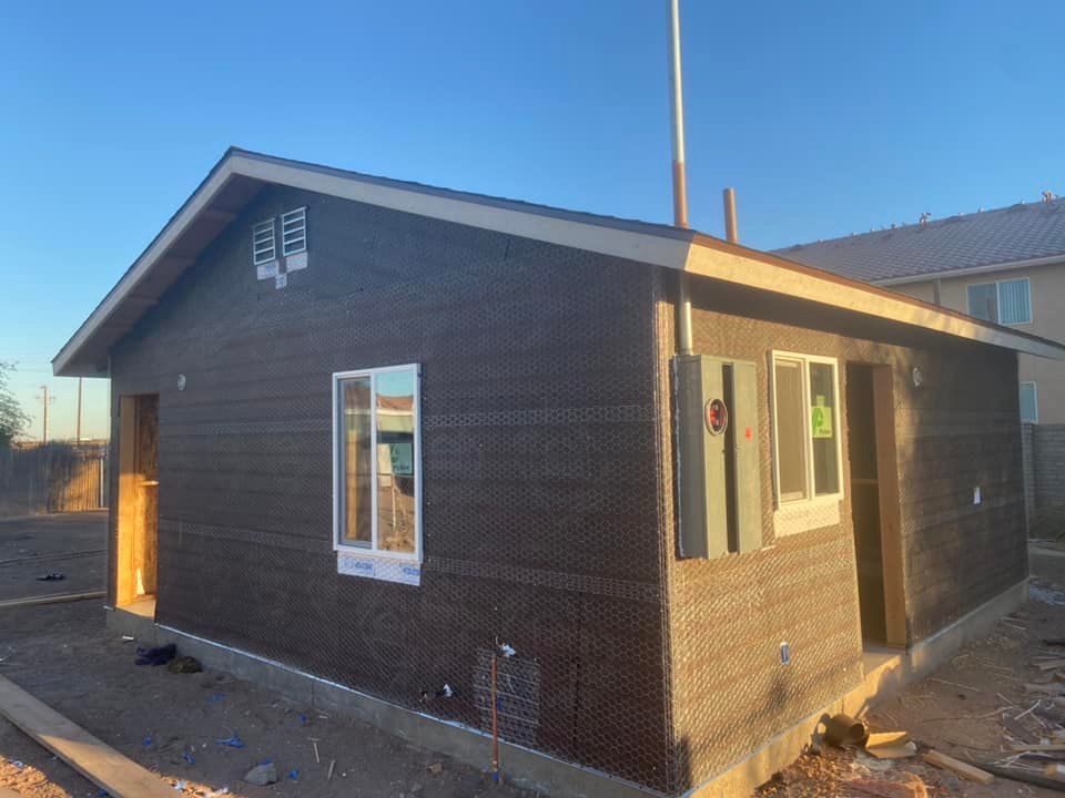 A small house with a lot of windows is being built.