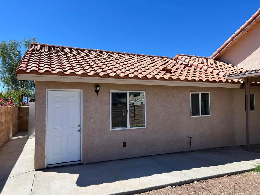 A small house with a tiled roof and a white door