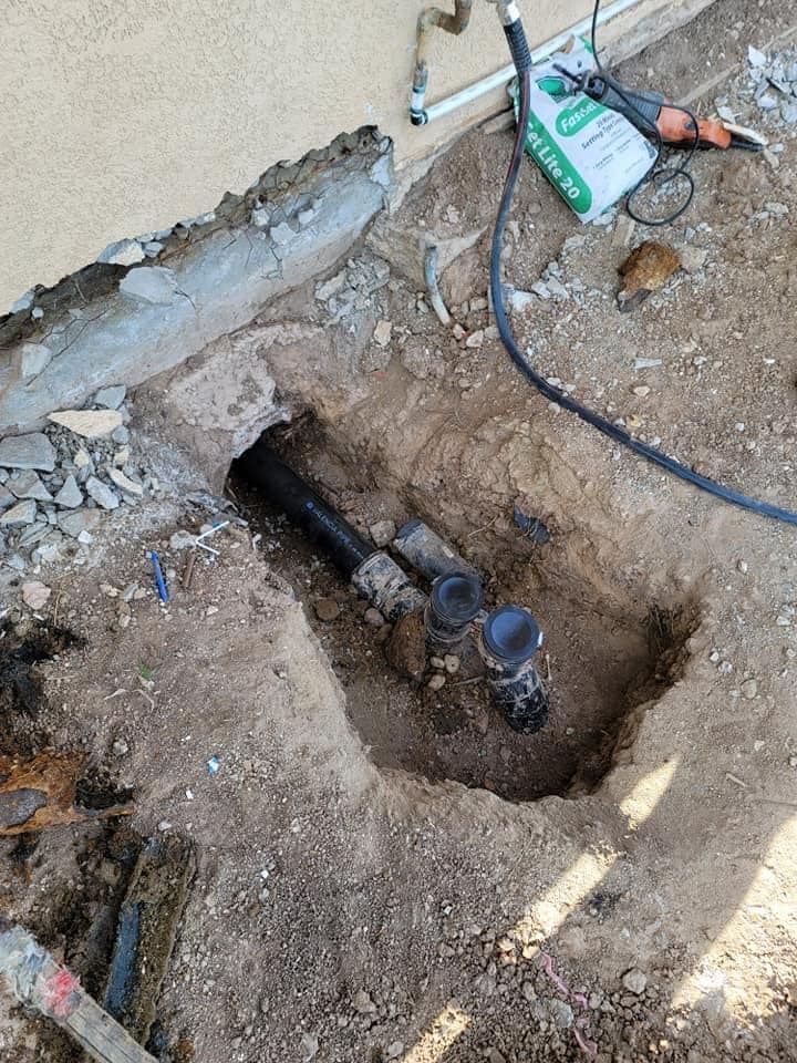 A water meter is being installed in a hole in the ground.
