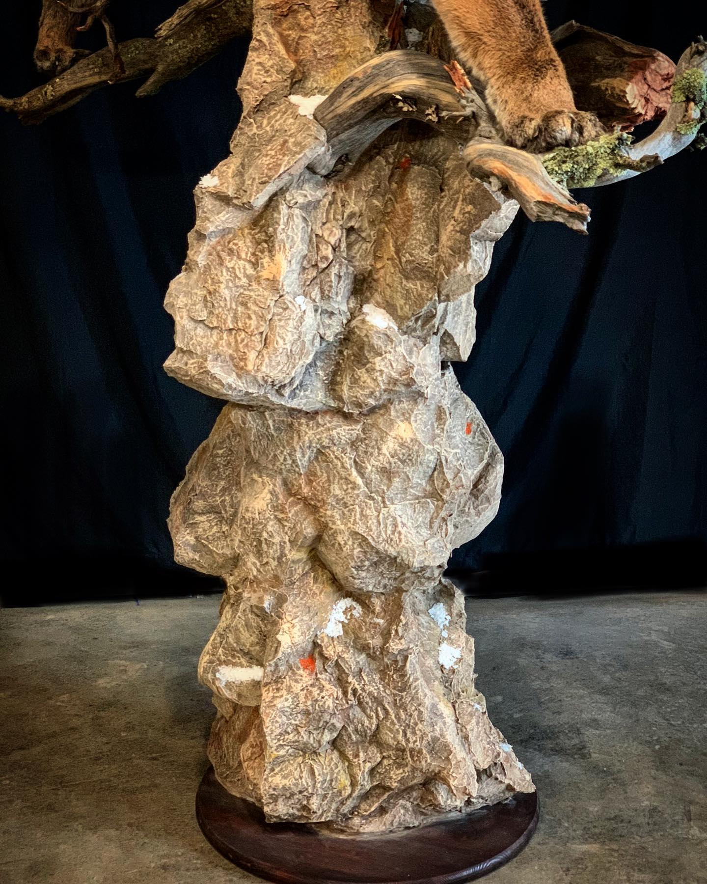 A statue of a bear sitting on top of a rock.