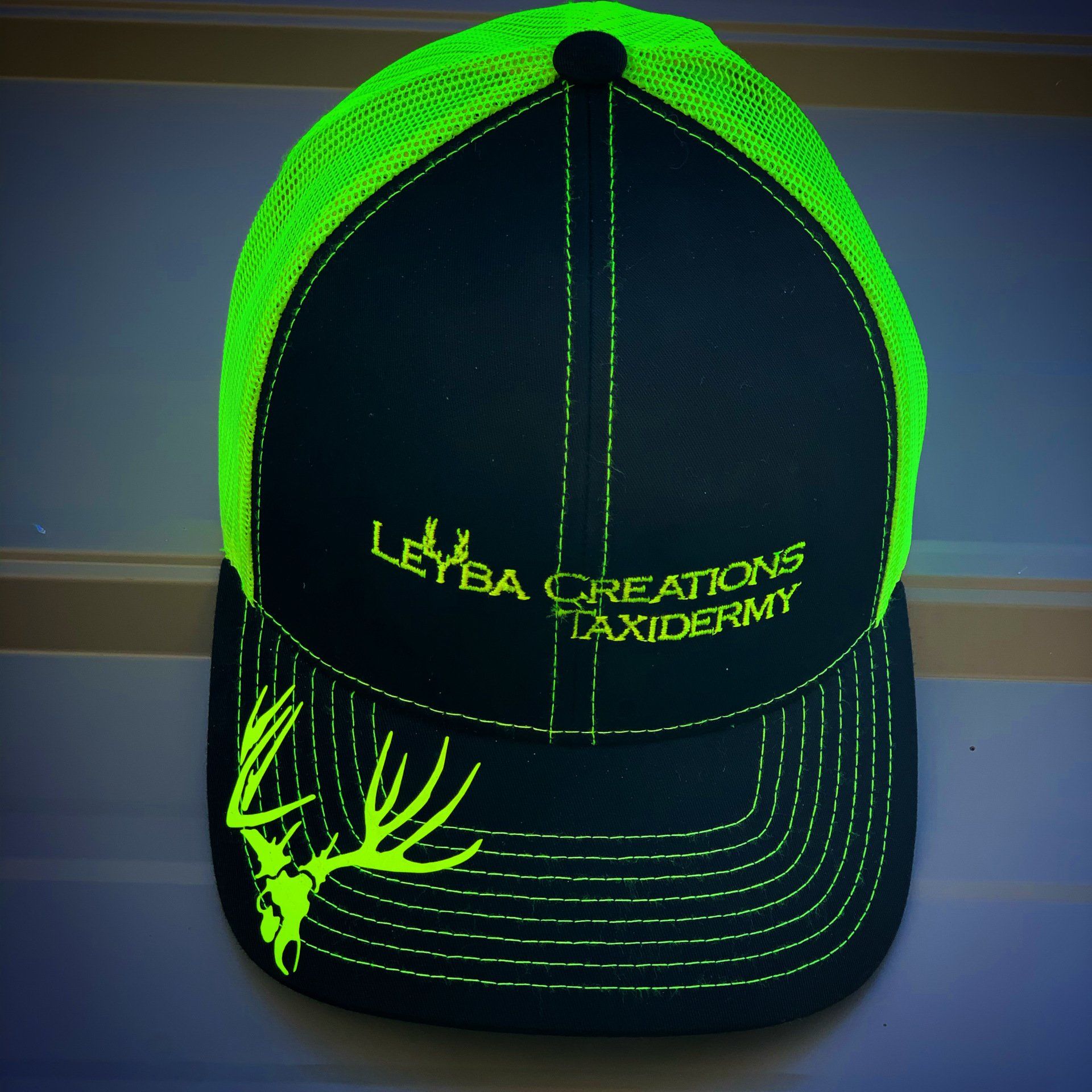 A black hat with leyba creations taxidermy written on it