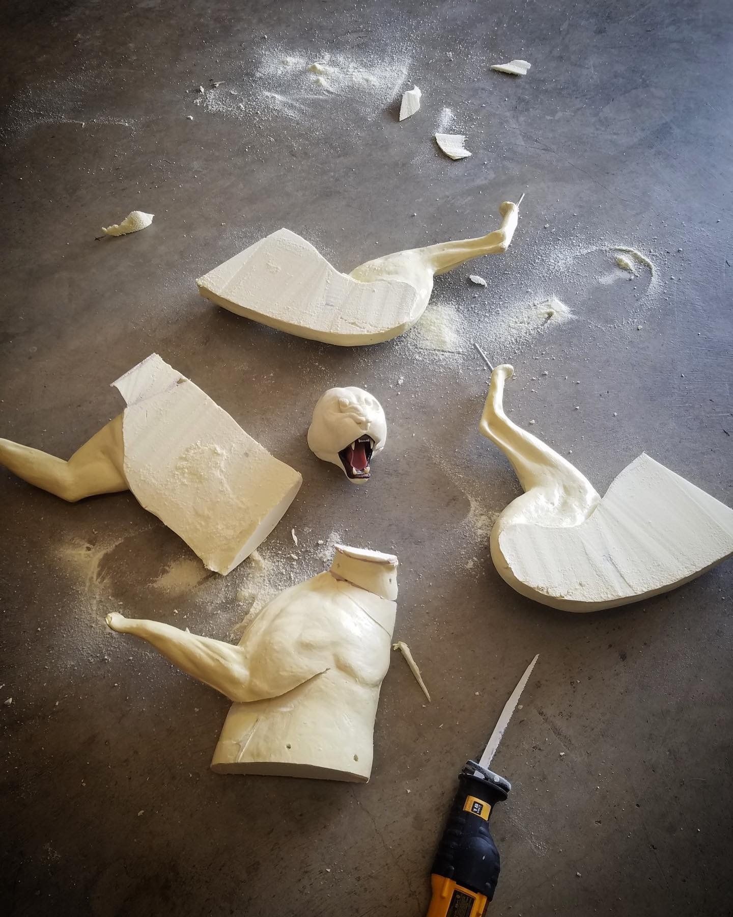 A piece of foam is laying on the floor next to a screwdriver