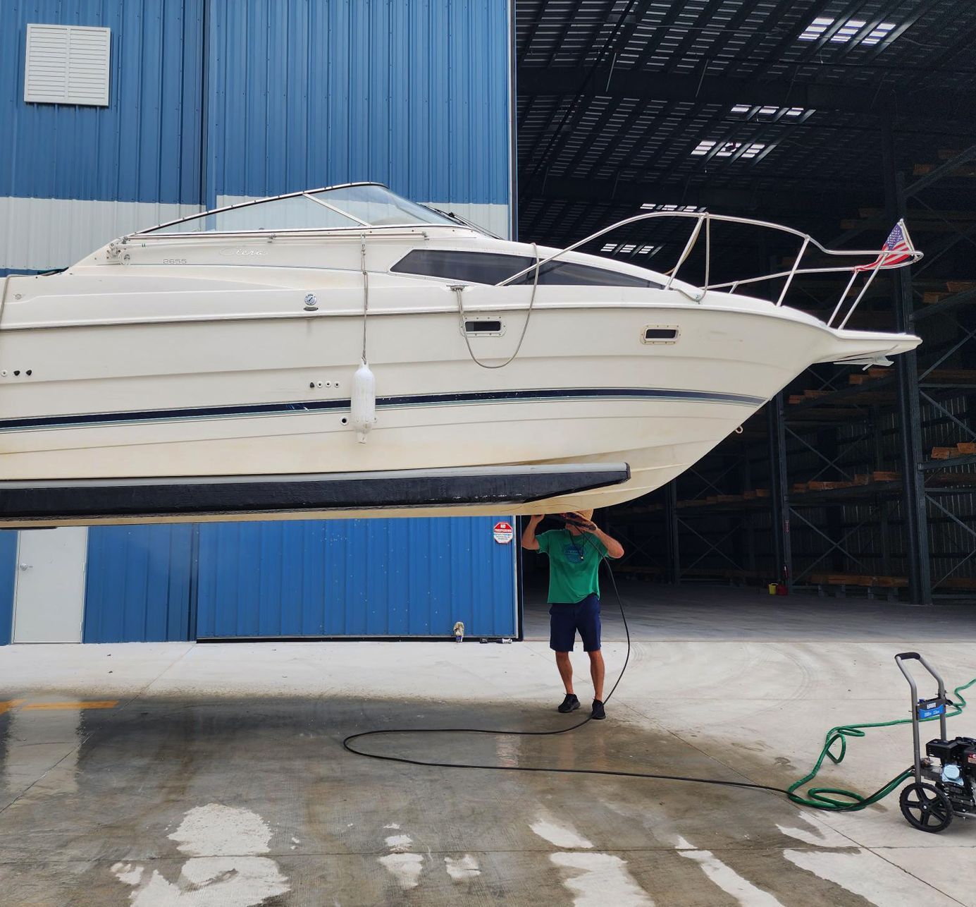 A man is standing next to a large white boat at Riverview Marina