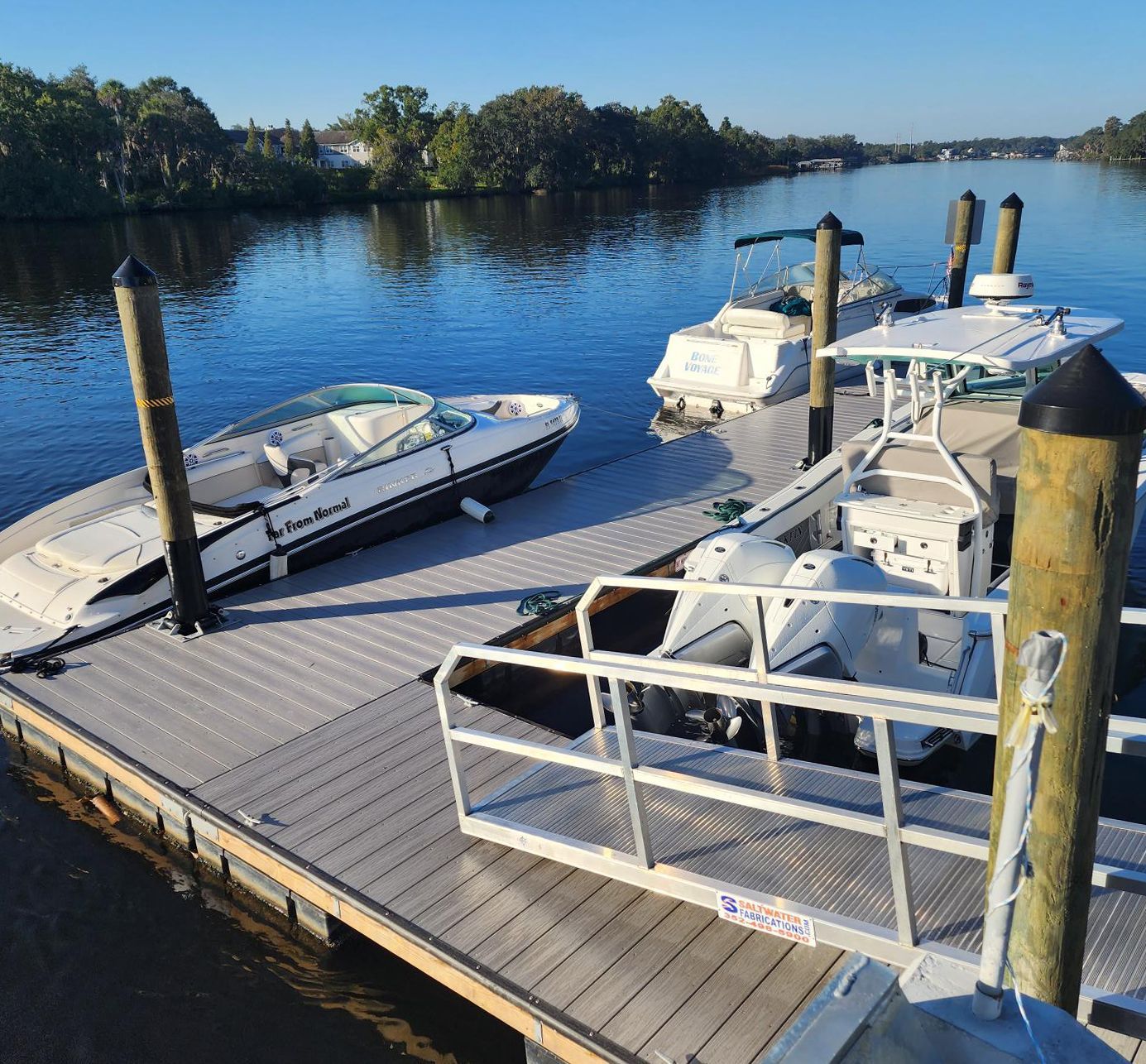 Several boats are docked at a dock on a lake at Riverview Marina