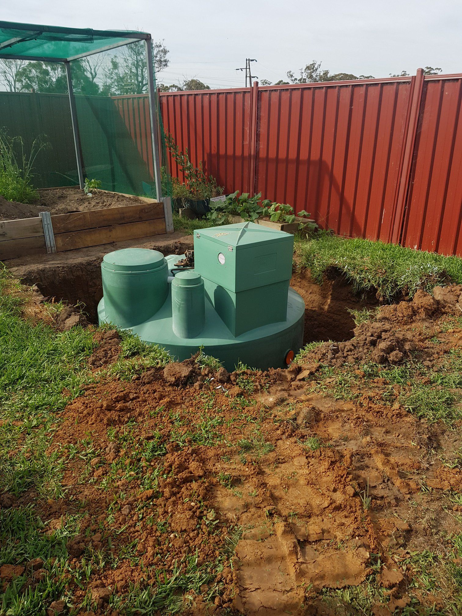 Green Septic Tank Installed in a Backyard — Mi Plumber Wagga Wagga in Lake Albert, NSW