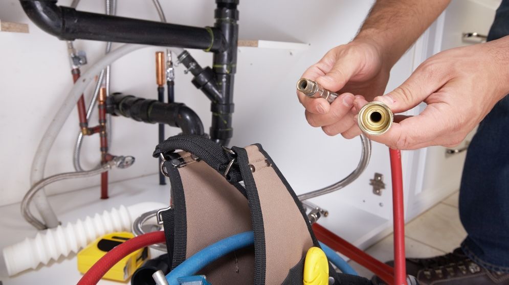 Plumber fixing pipes under the sink — Mi Plumber Wagga Wagga in Lake Albert, NSW