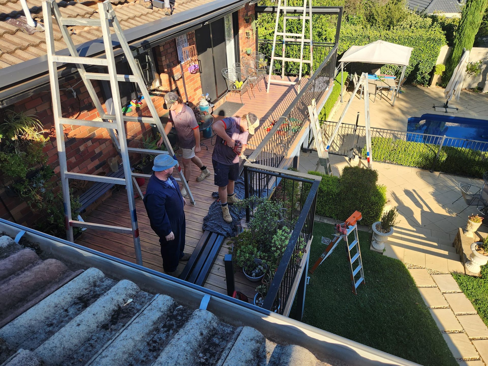 Workers on a Balcony With Ladders — Mi Plumber Wagga Wagga in Lake Albert, NSW