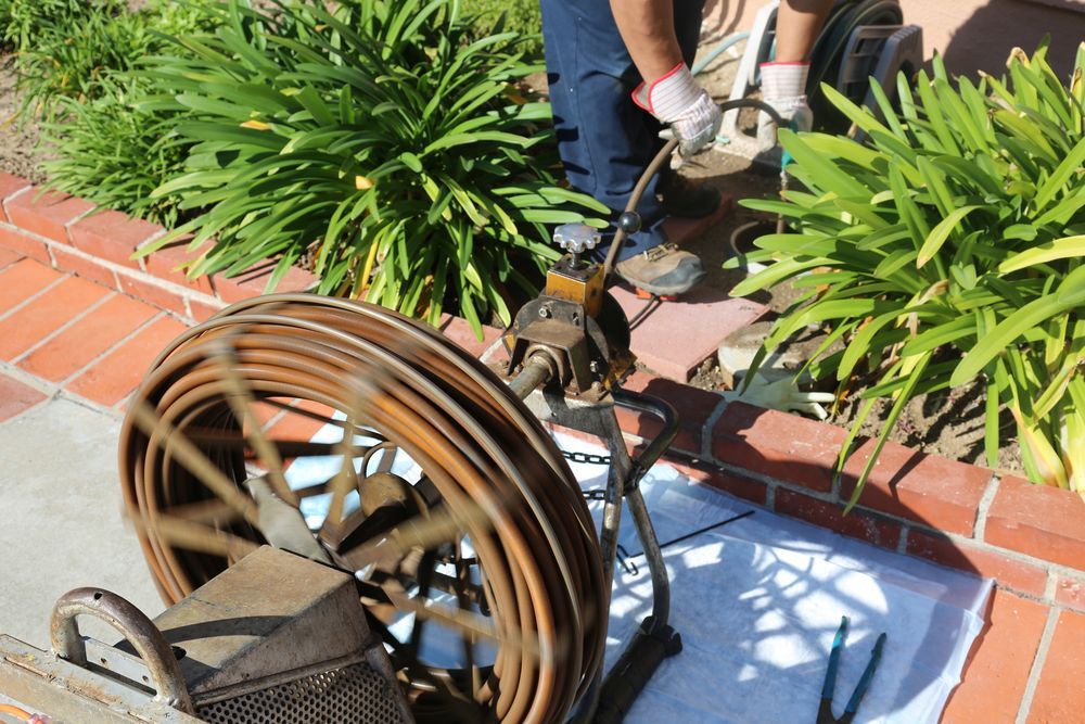 Blocked drain being fixed with snake tool — Mi Plumber Wagga Wagga in Lake Albert, NSW