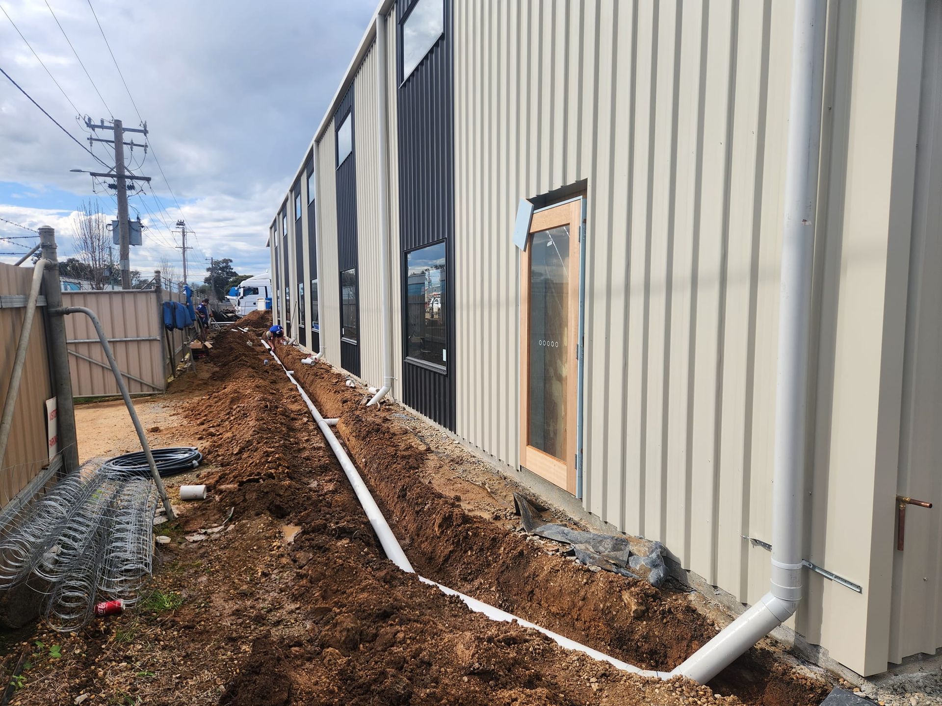 A Building With Beige Siding — Mi Plumber Wagga Wagga in Lake Albert, NSW