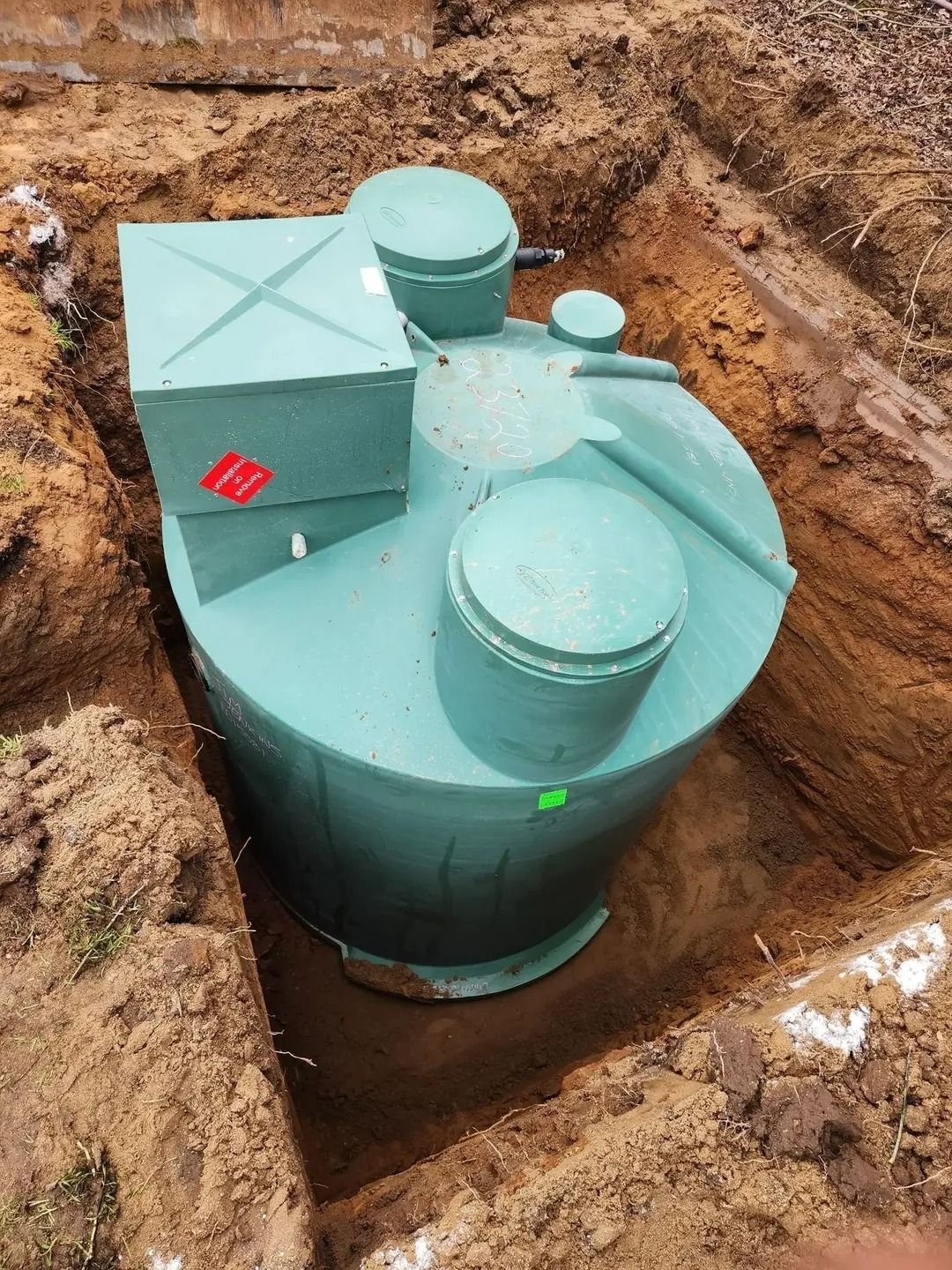 Green Septic Tank in an Excavated Dirt Pit — Mi Plumber Wagga Wagga in Lake Albert, NSW