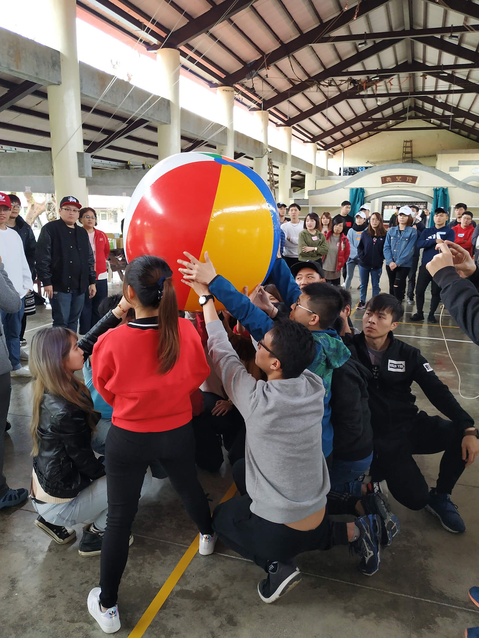 A group of people are playing with a beach ball.