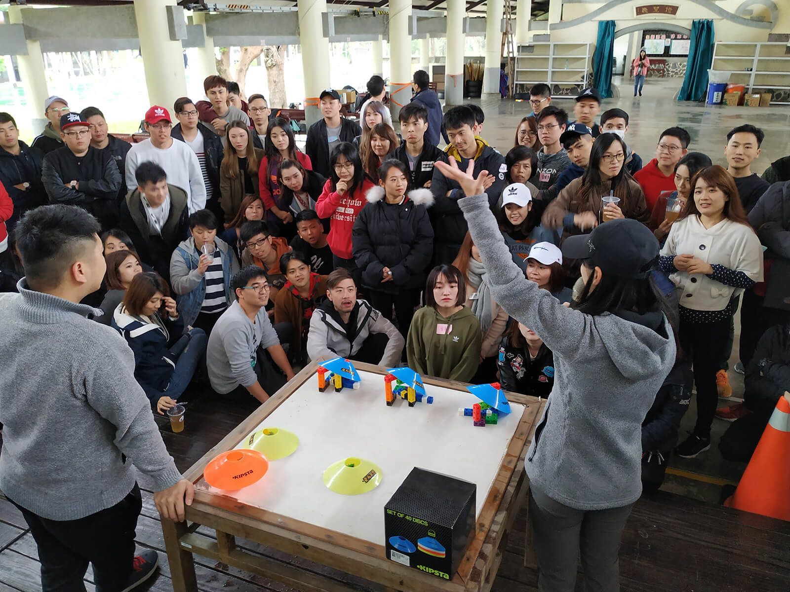A group of people are sitting around a table playing a game.