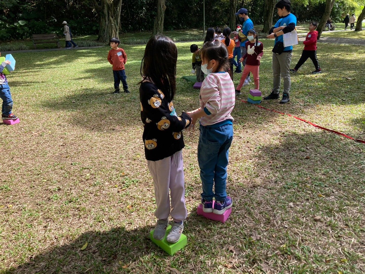 A group of children are playing in a park.