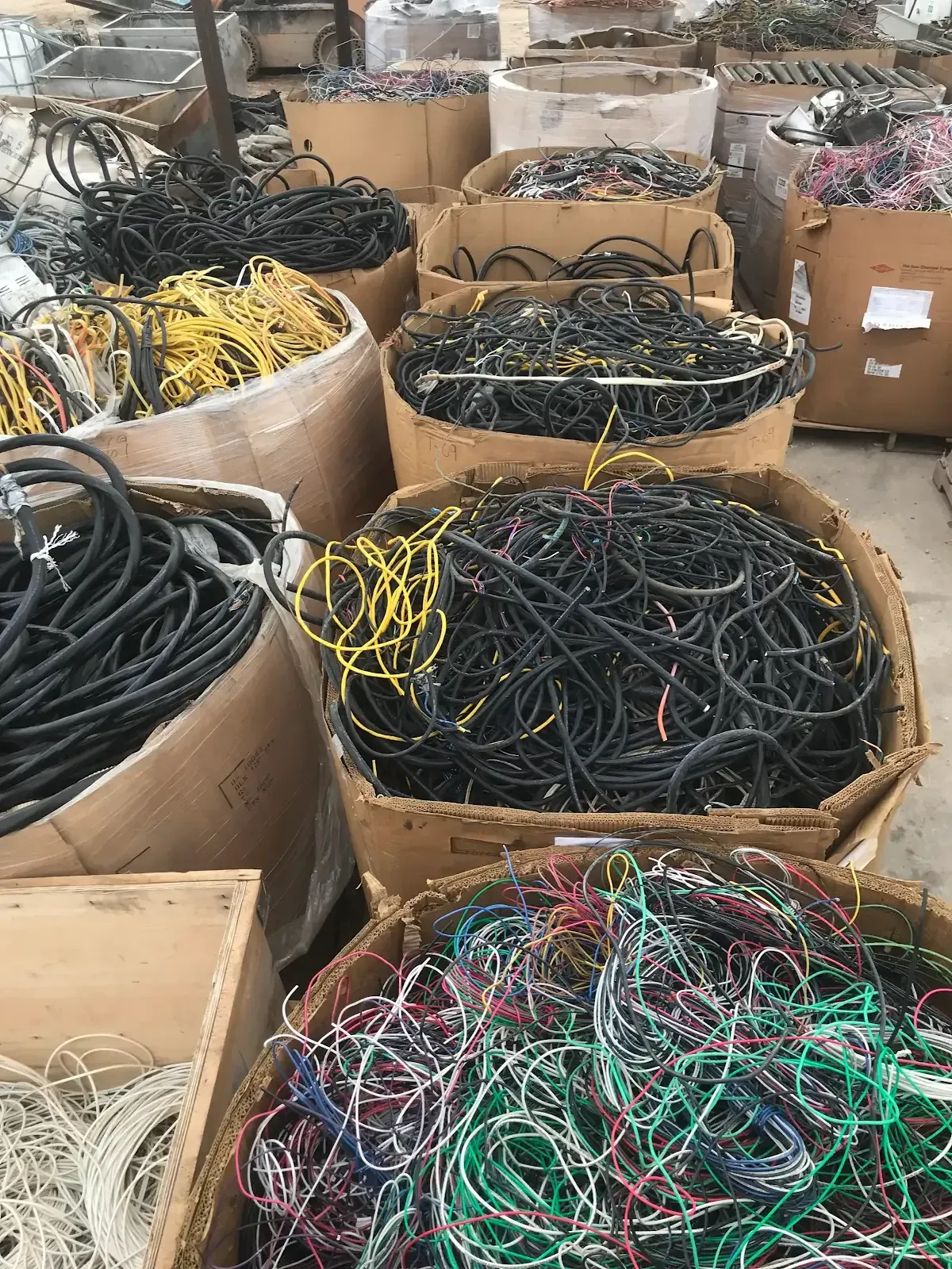 Woman in straw hat smiles, holding wine glass near a lake.