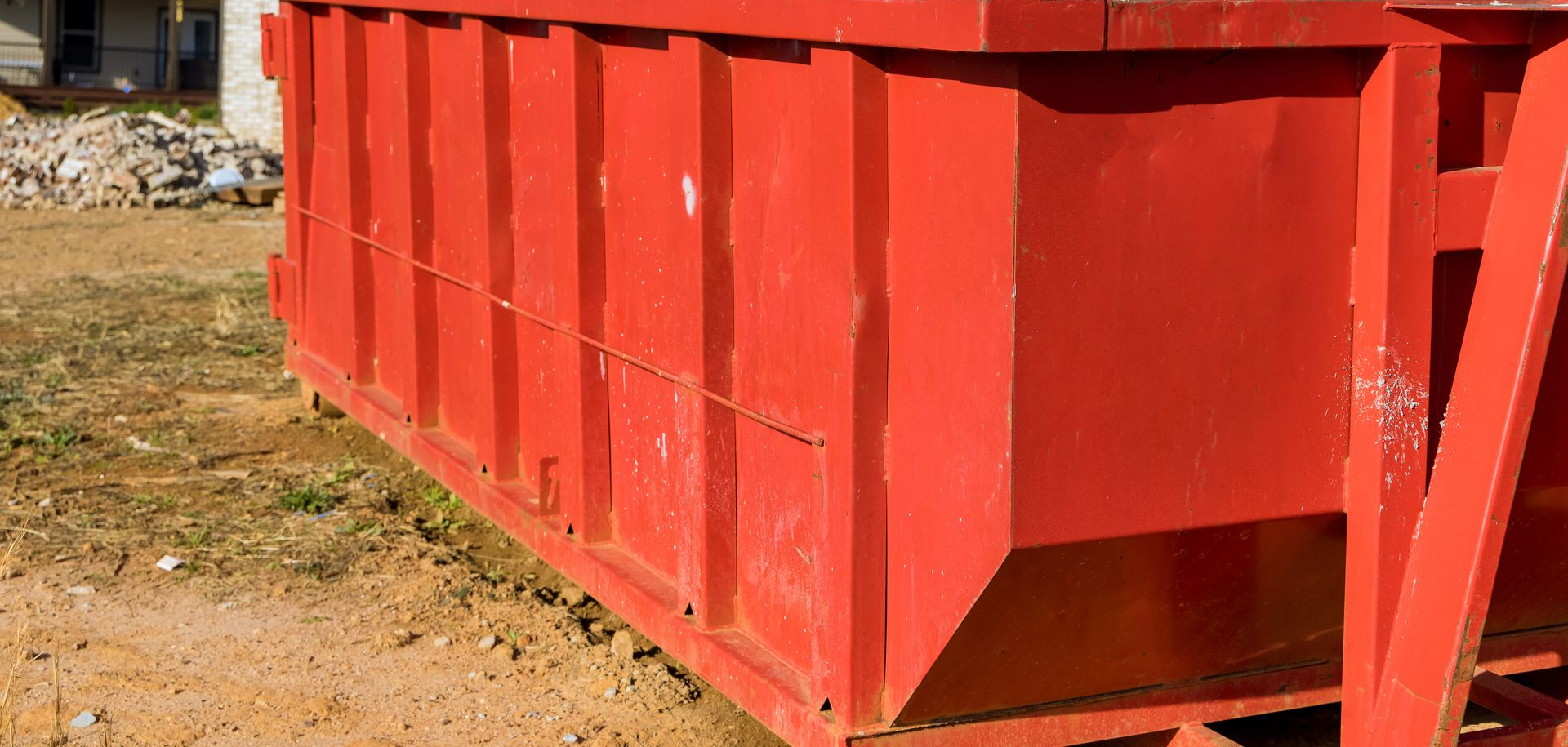 A person holding a baby up in the air indoors near a window, baby smiling.