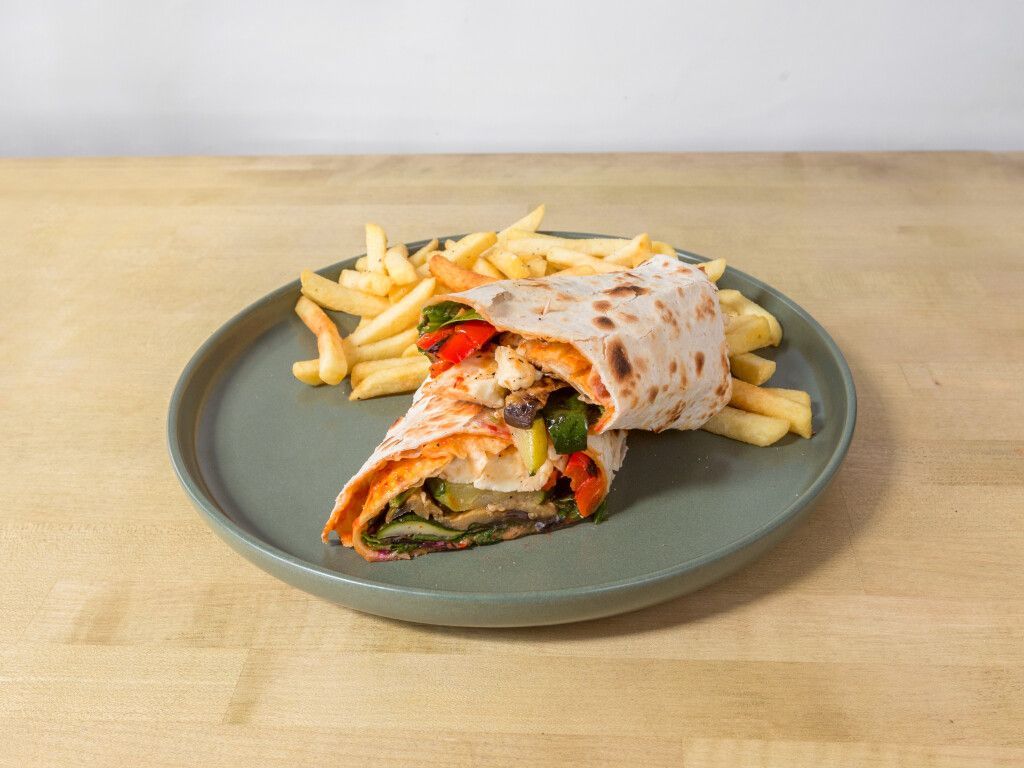 Wrap with vegetables and fries on a plate.