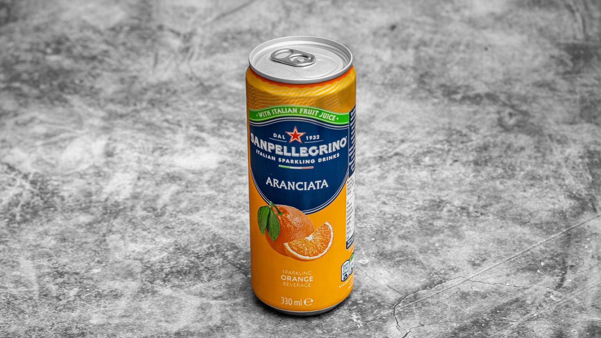 Orange San Pellegrino Aranciata can on a gray background.