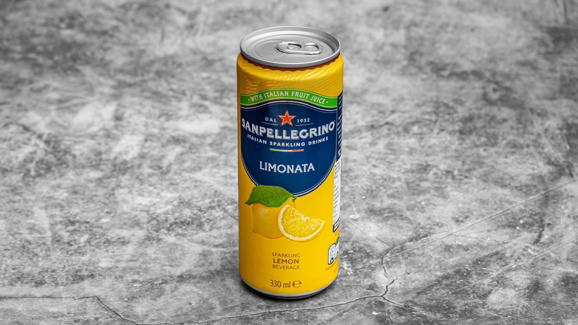 Sanpellegrino Limonata can on a gray surface, yellow and blue label, with lemon and leaf illustrations.