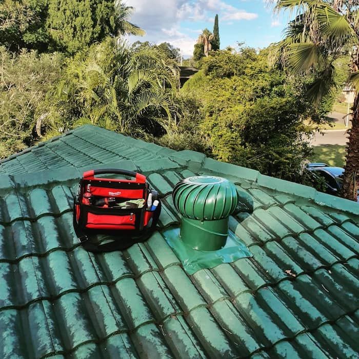 A Green Roof with A Red Tool Bag on It — Origin Plumbing & Gas in Tuckurimba, NSW
