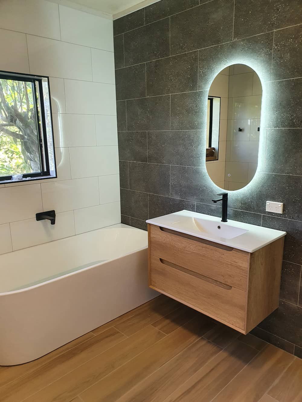 A Bathroom with A Sink, Bathtub and Mirror — Origin Plumbing & Gas in Tuckurimba, NSW