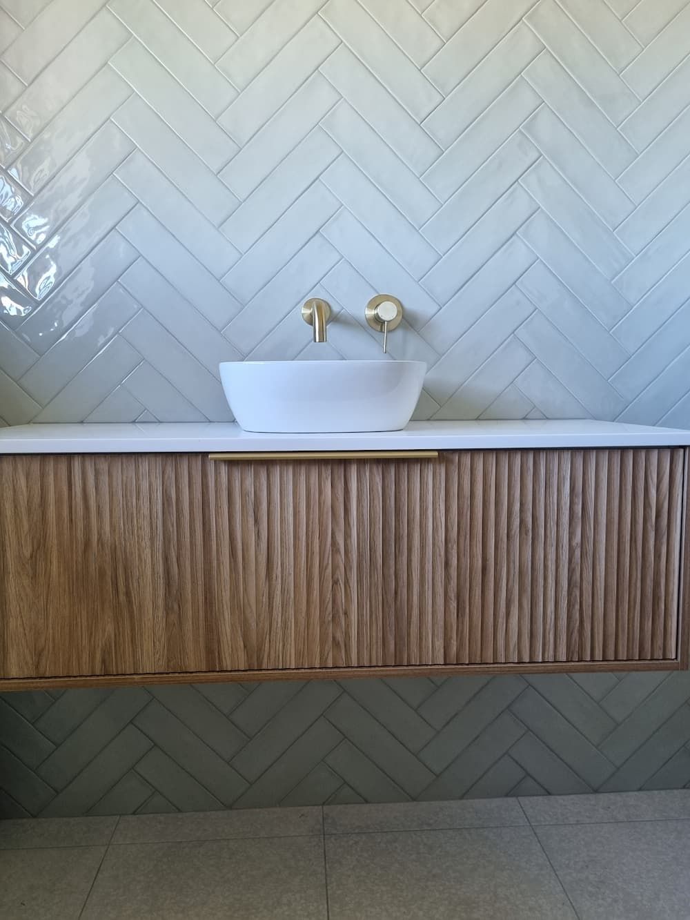 A Bathroom with A Sink and A Wooden Cabinet — Origin Plumbing & Gas in Tuckurimba, NSW