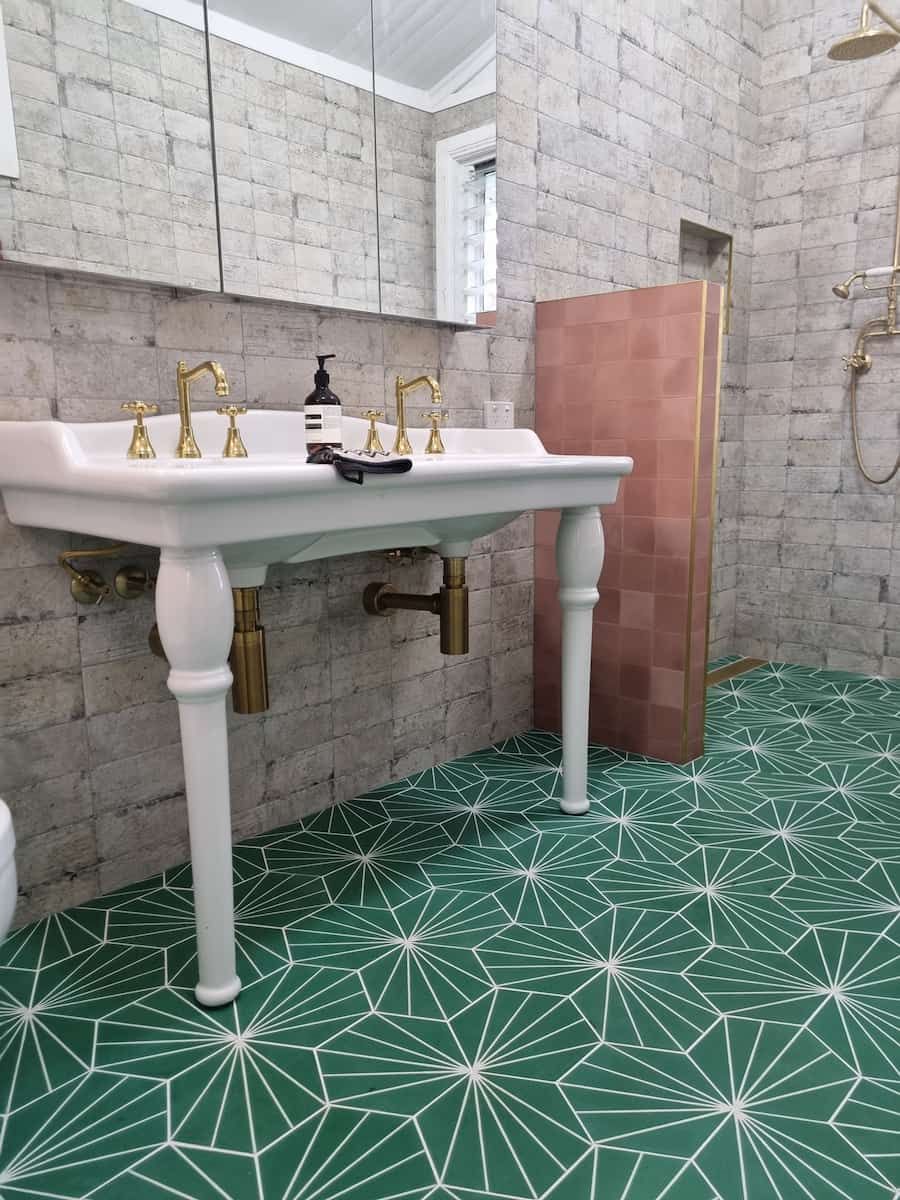 A Bathroom with A Sink, Shower and Green Tiles — Origin Plumbing & Gas in Tuckurimba, NSW