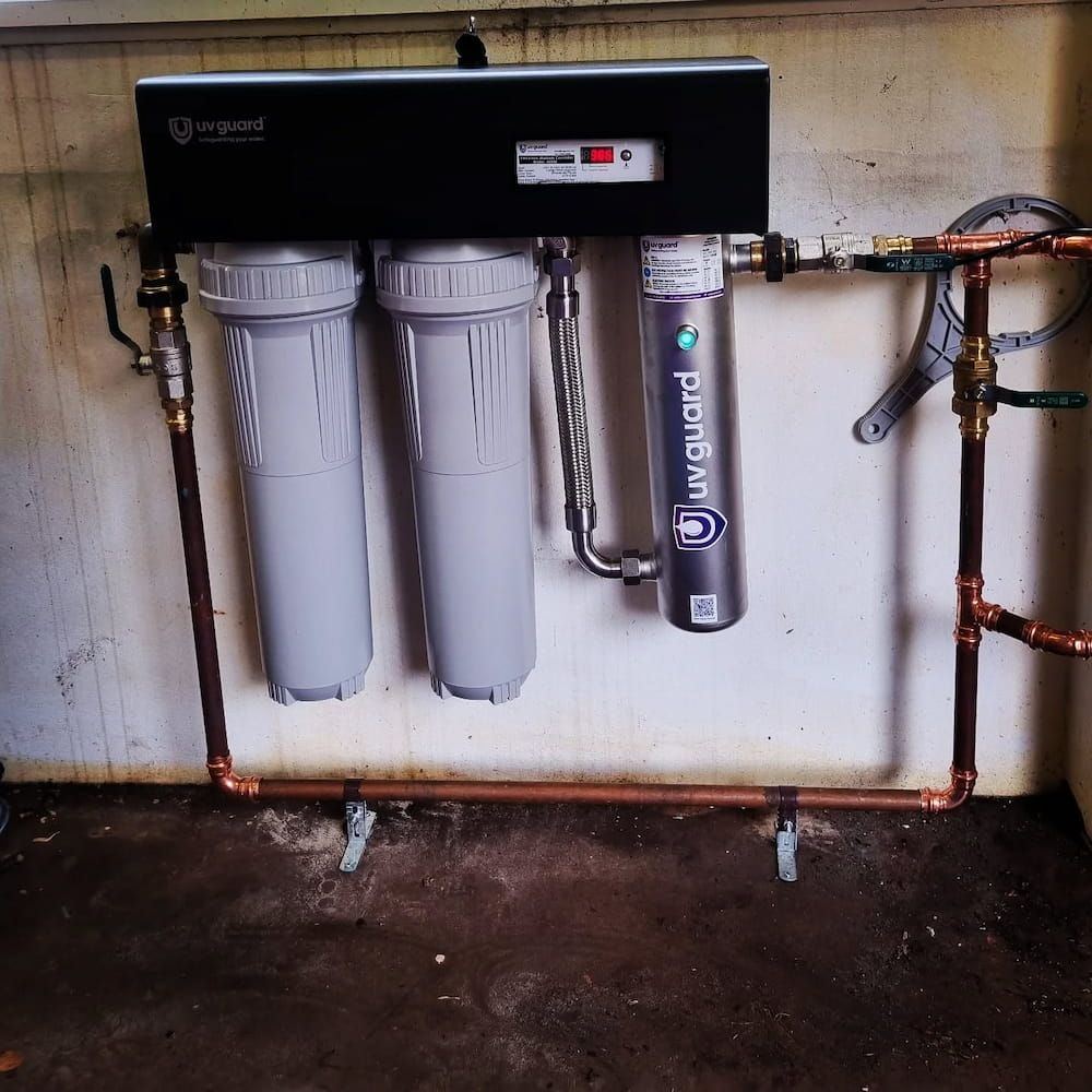 A UVguard Water Filter Is Attached to A Wall — Origin Plumbing & Gas in Tuckurimba, NSW