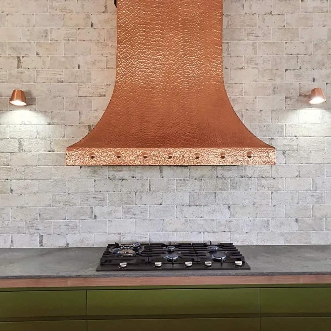 A Copper Hood Above the Stove in The Kitchen — Origin Plumbing & Gas in Tuckurimba, NSW