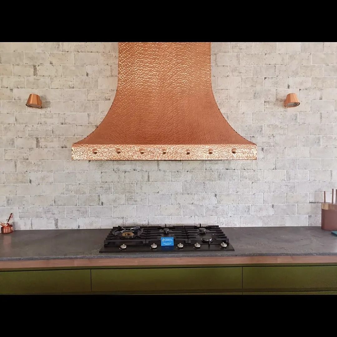 A Kitchen stove with golden-like fan over hob — Origin Plumbing & Gas in Tuckurimba, NSW