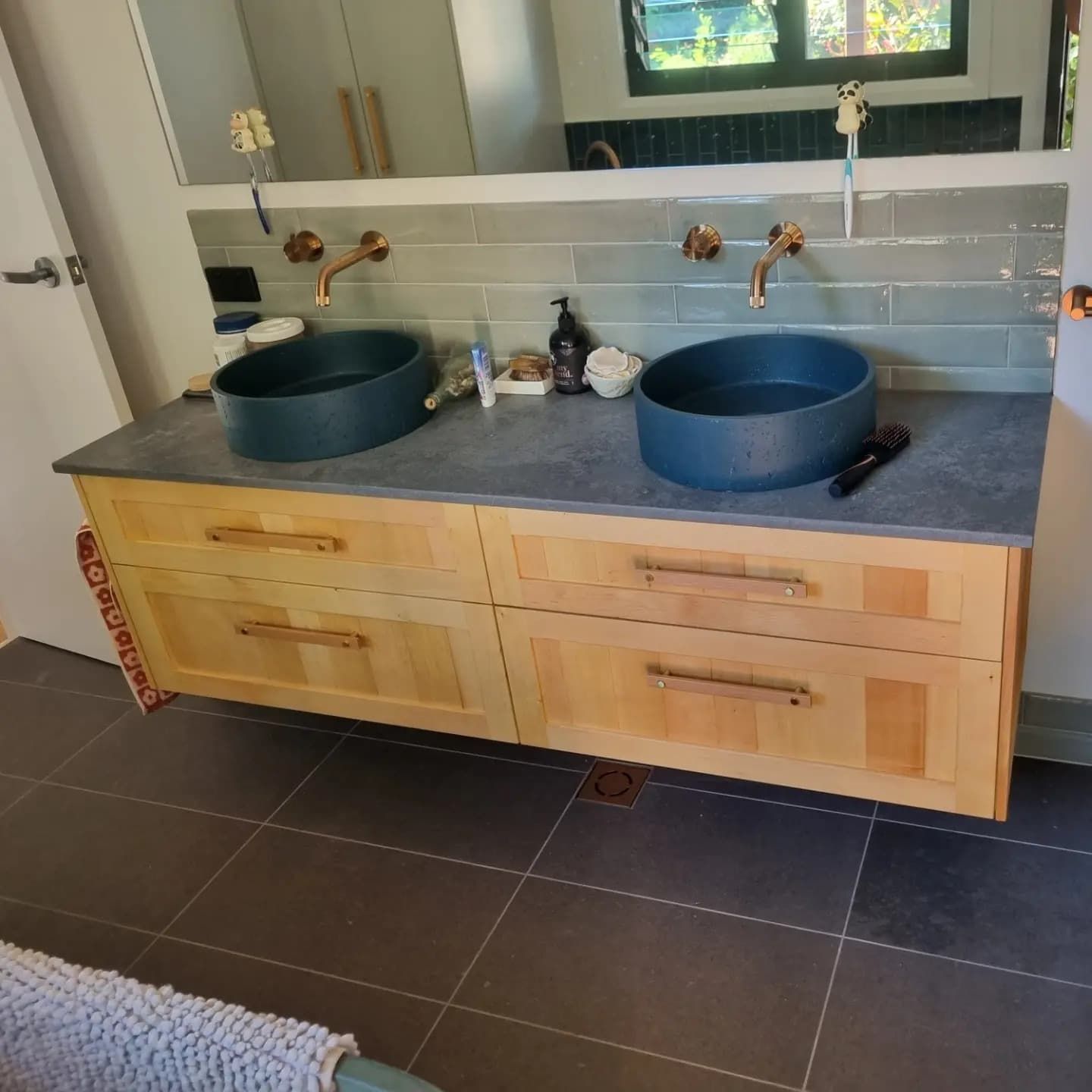 A Bathroom with Two Sinks and A Mirror — Origin Plumbing & Gas in Tuckurimba, NSW