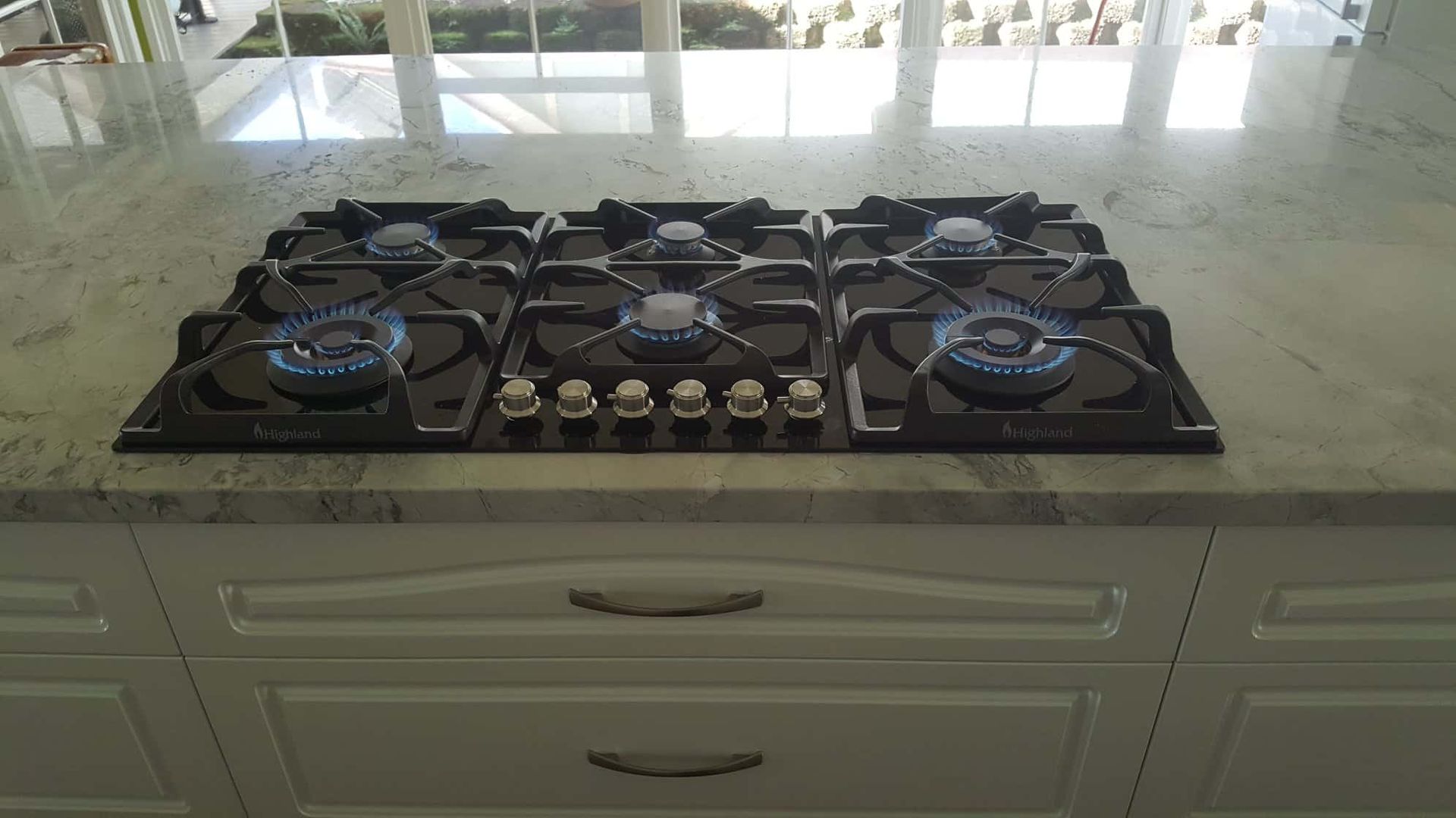 A Gas Stove Is Sitting on Top of A White Counter in A Kitchen — Origin Plumbing & Gas in Tuckurimba, NSW
