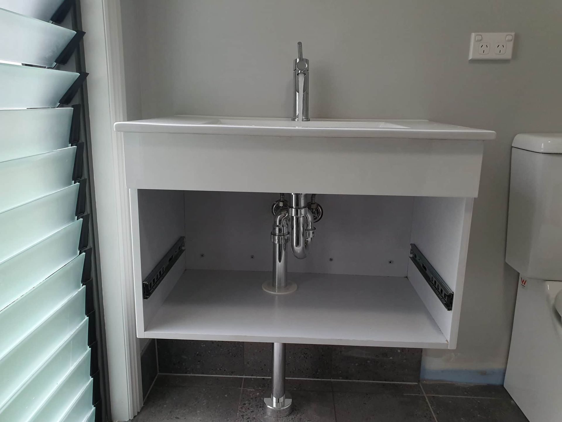 A Bathroom Sink with A Drain Underneath It — Origin Plumbing & Gas in Tuckurimba, NSW
